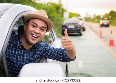 Asian Man Sit In Car And Showing Thumb Up