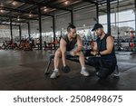 Asian man sitting on a stool with personal trainer,Hire a professional trainer to teach weight training,body and healthy cardio sports workout