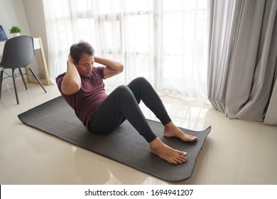 Asian Man Sitting Up Workout From Home In The Morning