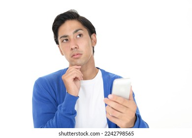 asian man with smart phone - Shutterstock ID 2242798565