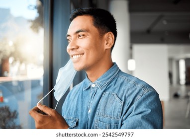 Asian man, smile and removing face mask for public health, pandemic and wellness as relief or safety. Male person, protection and illness prevention in office for communication, comfort and hygiene - Powered by Shutterstock