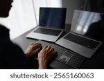 Asian man software engineer Working on Computer at office desk for writing program code IT Software Engineer finding errors tech support devops creating digital.
