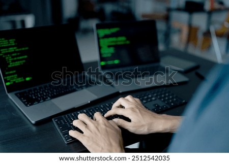 Asian man software engineer Working on Computer at office desk for writing program code IT Software Engineer finding errors tech support devops creating digital.