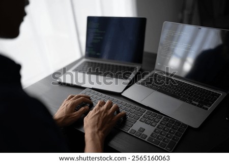 Asian man software engineer Working on Computer at office desk for writing program code IT Software Engineer finding errors tech support devops creating digital.