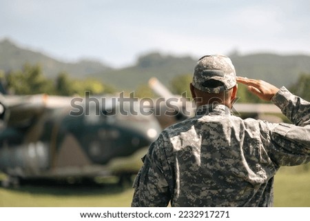 Asian man special forces soldier standing against on the field Mission. Commander Army soldier military defender of the nation in uniform while state of war.