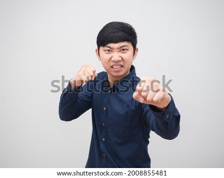 Asian man stance and punch serious face  portrait white background