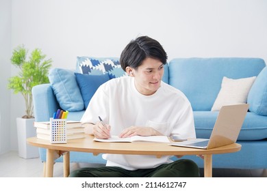 Asian man studying in an online course. at home - Shutterstock ID 2114612747