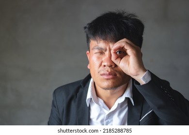 A Asian Man With Suit Is See Through The Hand Circle, Finding And Watching Business Concept With Copy Space For Text