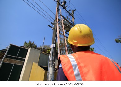 The Asian Man Supervisor Monitored The Cable Replacement Work, Wearing Orange Vest And Safety Helmet