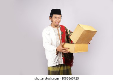 Asian Man Surprised Happy For Gift In Ied Mubarak Muslim. Asian Man Open Gift Ied Mubarak Muslim Present.