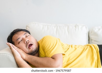 Asian Man Take A Nap On Sofa With Snore.take Nap Daydreaming In Living Rooms Snoring.Healthcare Medical.Sleep Health.man Sleep At Home.Dream, Rest, Tired Father Dad Day.Sleep Apnea.Sdb.resting At Home