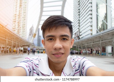 Asian Man Take Photo Selfie In City 