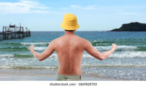 Asian Man Taking Off His Shirt On A Beautiful Beach In Summer