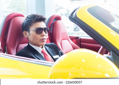 Asian Man Testing New Sports Car