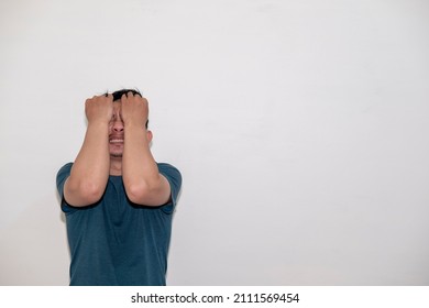 An Asian Man With A Thin Mustache Made An Annoyed And Angry Expression. Plain Background.