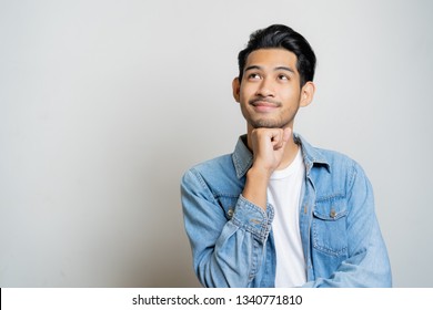 Asian Man Thinking And Smiling.