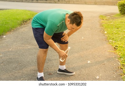 Asian man tired from running exercise.