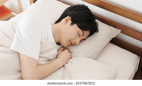 Asian man tossing and turning