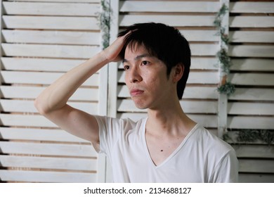 A Asian Man Touching Hair