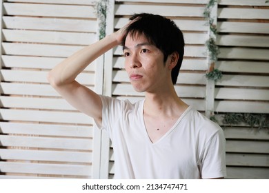 A Asian Man Touching Hair