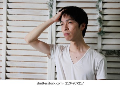 A Asian Man Touching Hair