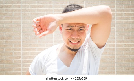 Asian Man Under Hot Bright Sun. Asian Man In White Shirt. Asian Man With Black Beard.