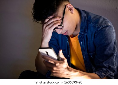 Asian Man Is Upset While Using Smart Phone Outdoor In The Evening