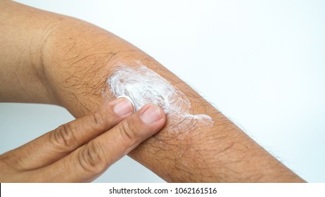 Asian Man Use His Fingers To Apply White Cream On His Arm