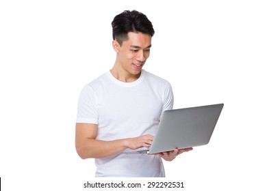 Asian Man Use Of The Laptop Computer