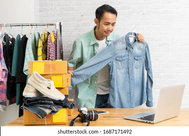 Asian Man Using Computer Laptop Selling Online Denim Shirt, Start Up Small Business Owner E-commerce Working At Home Office