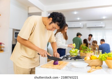 Asian Man Using Knife Cutting Fresh Red Cabbage On Cutting Board In The Kitchen At Home. Happy Female Enjoy Cooking And Having Dinner Eating Healthy Food On Holiday Vacation