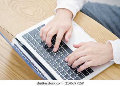 Asian Man Using The Laptop At Home, No Face