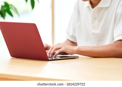 Asian Man Using The PC At Home, No Face