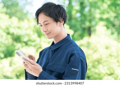 Asian man using a smart phone - Powered by Shutterstock