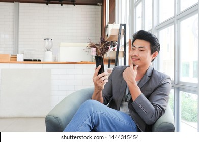 Asian Man Using Smartphone For Shopping Online,A Man Using Net Banking In Smartphone,Shopping Online In Coffee Shop,Business And Investment Online,Social Network