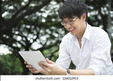 Asian Man Using Tablet