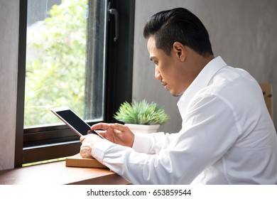 Asian Man Using Tablet At Cafe, 30-40 Year Old.