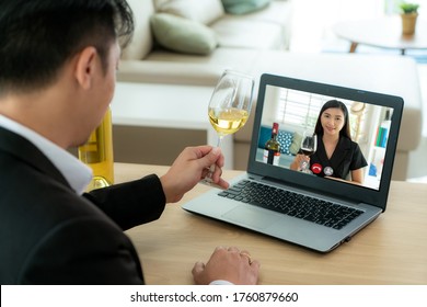 Asian Man Virtual Happy Hour Meeting Party And Drinking White Grape Wine Online Together With His Friend In Video Conference With Digital Tablet For A Online Meeting In Video Call 