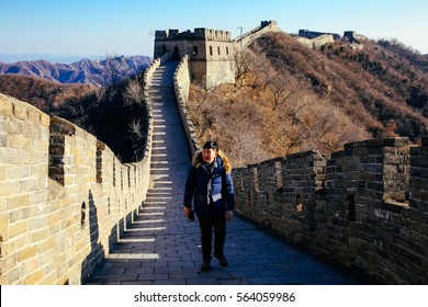 Asian Man Walking On Great Wall Of China - Travel In China, Asia Concept