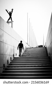 Asian Man Walking Up The Stairs. Concept Of Black And White Photography.