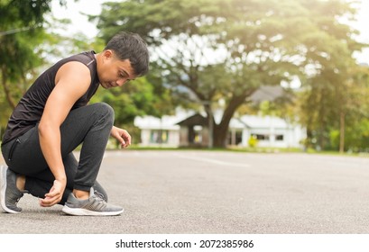 Asian Man Warming Up And Cool Down To Exercise In The Park