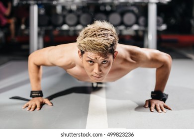 Asian Man Warming Up And Doing Some Push Ups A The Gym