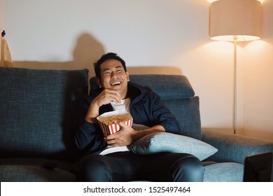 Asian Man Watching Movie At Home.