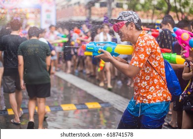 Asian Man With Water Gun Wearing Summer Shirt In Songkran Festival (water Festival), Thailand.