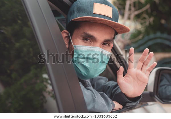 Asian man wear face mask in\
car