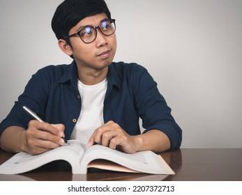 Asian Man Wear Glasses Studying With Gentle Smile