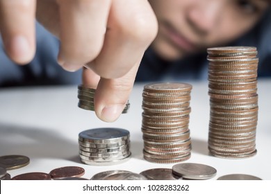 Asian Man Wearing A Blue Shirt Is Counting On His Money. Saving Money Concept