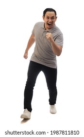 Asian Man Wearing Grey Shirt Black Denim And White Shoes, Screaming Shouting Celebrating Victory, Winning Gesture. Full Body Portrait Isolated Cut Out