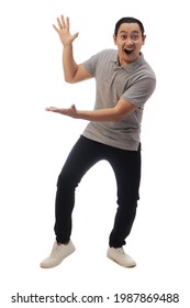 Asian Man Wearing Grey Shirt Black Denim And White Shoes, Shocked Surprised Happy Cheerful Expression Presenting Pointing To Side With Copy Space. Full Body Portrait Isolated Cut Out