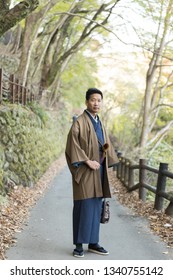 Asian Man Wearing Kimono In Autumn.